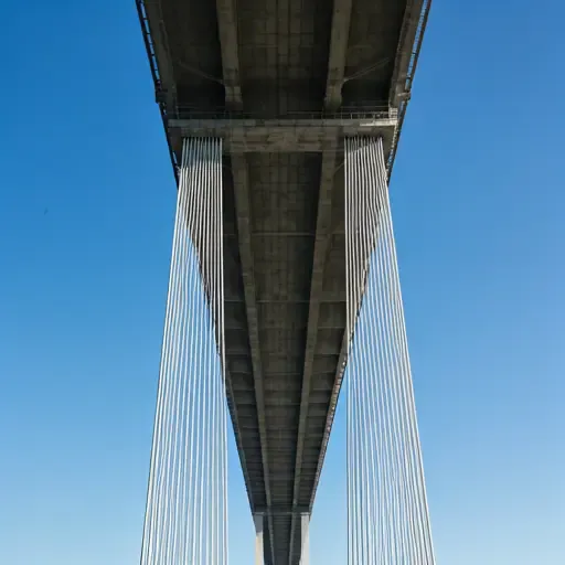 Close up drone inspecting the underside of a large suspension bridge